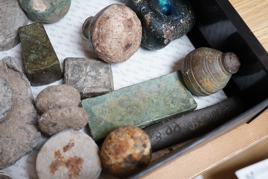 A collection of Roman and other ancient lead weights in various forms bearing various cast marks, together with a cast iron pointer the handle in the form of a head